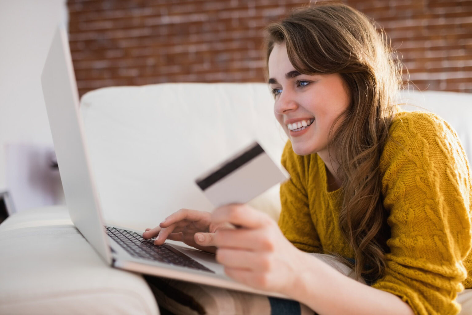 A shopper pays for her order online on a computer